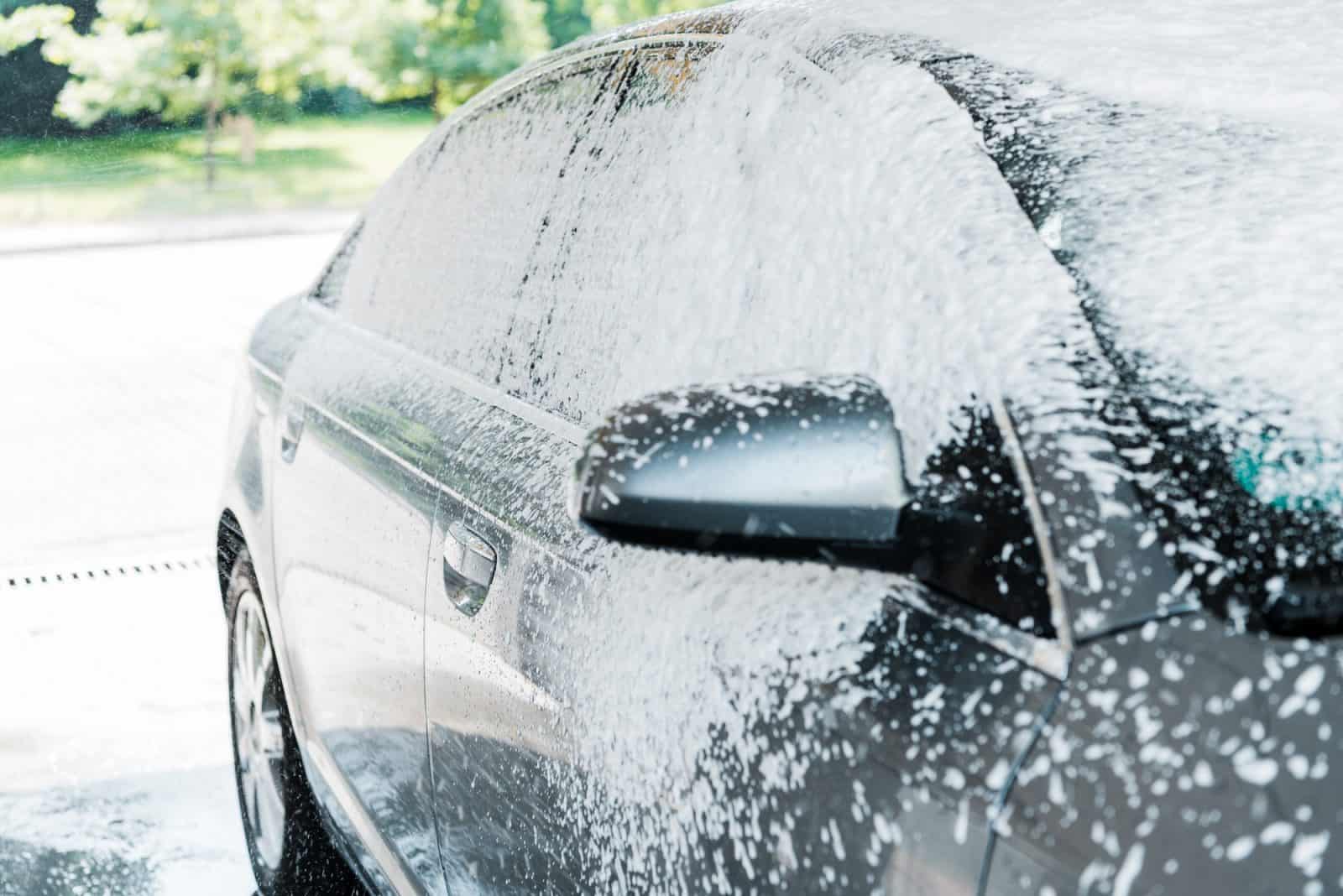 white foam on modern auto in car wash